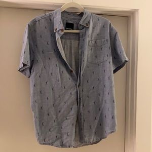 Blue button down shirt sleeve with cactus design